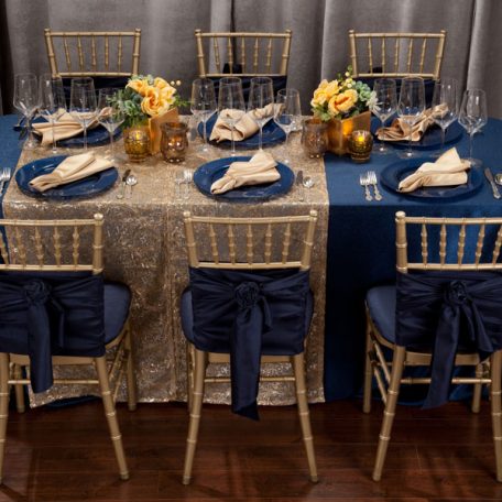Blue Cotier Table Linen with Golden Helena Table Runner, Goldmine Matte Satin Napkins and Blue Lino Limoges Glass Chargers