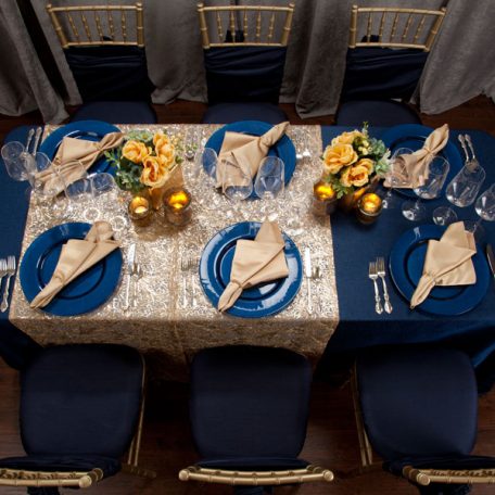 Blue Cotier Table Linen with Golden Helena Table Runner, Goldmine Matte Satin Napkins and Blue Lino Limoges Glass Chargers