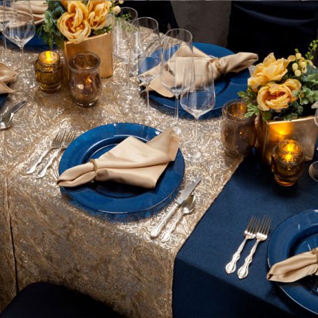 Blue Cotier Table Linen with Golden Helena Table Runner, Goldmine Matte Satin Napkins and Blue Lino Limoges Glass Chargers