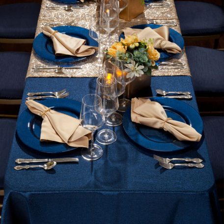 Blue Cotier Table Linen with Golden Helena Table Runner, Goldmine Matte Satin Napkins and Blue Lino Limoges Glass Chargers
