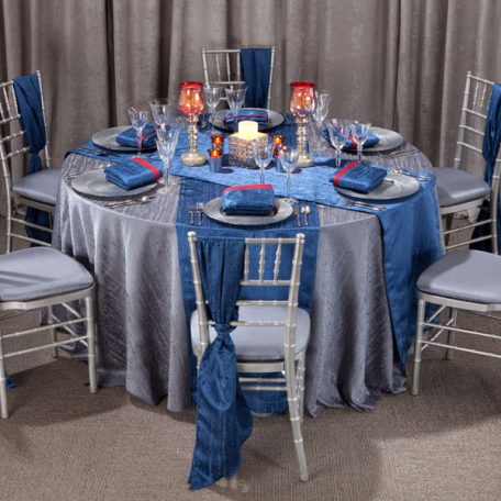 Gunmetal Contour Table Linen with Lapis Contour Table Runners and Napkins on top of our Silver Tidal Wave Charger.