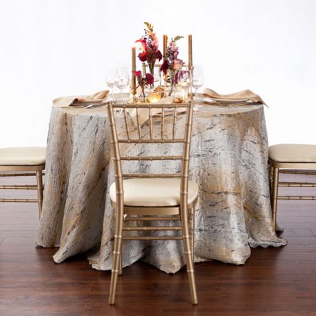 Pyrite Marble Table Linen with our Ice with Gold Rimmed Charger topped off with a Gold Lamour Napkin