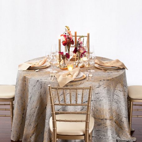 Pyrite Marble Table Linen with our Ice with Gold Rimmed Charger topped off with a Gold Lamour Napkin